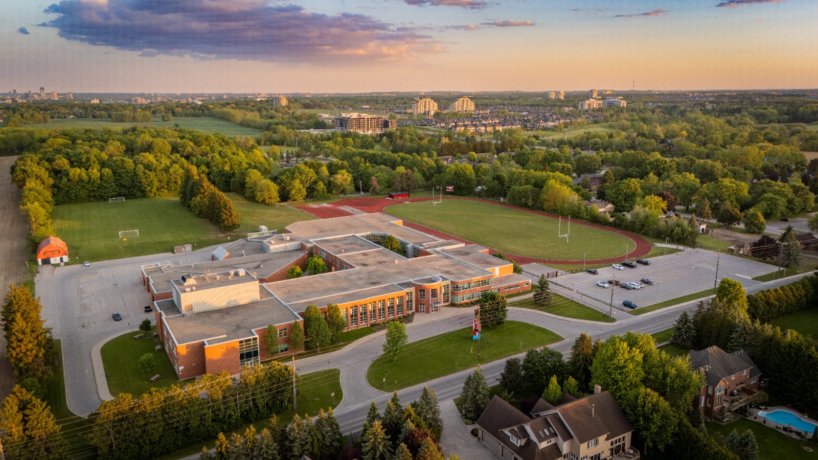 Completed aerial shot of Medway High School at golden hour with the London skyline on the horizon