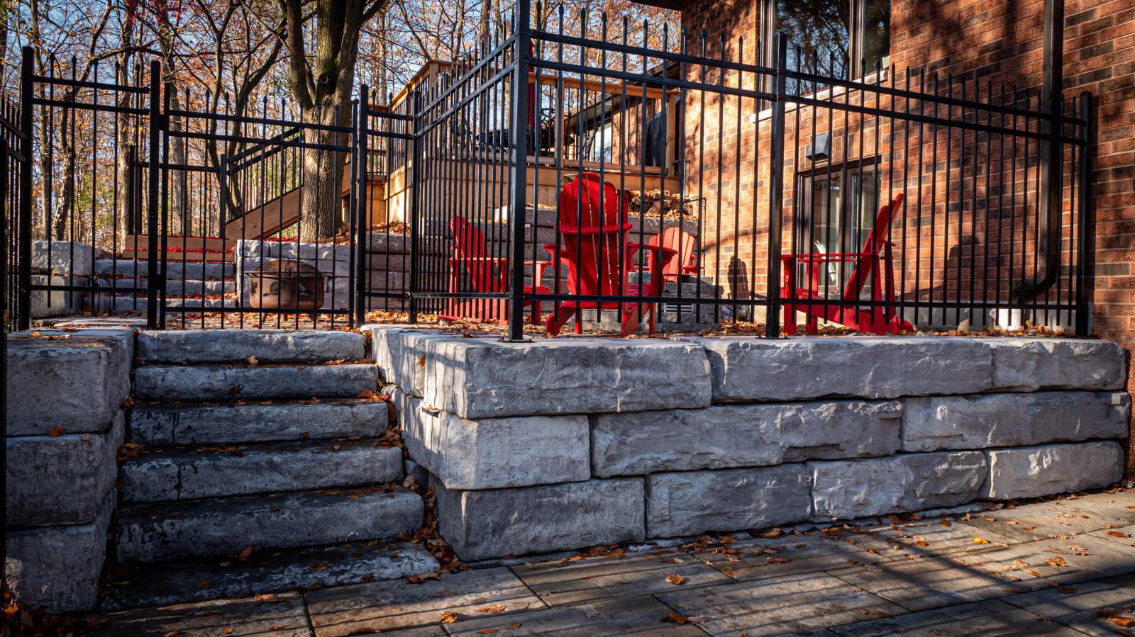 Raised patio retaining wall built with Brown's Concrete Products Grand Ledge block.