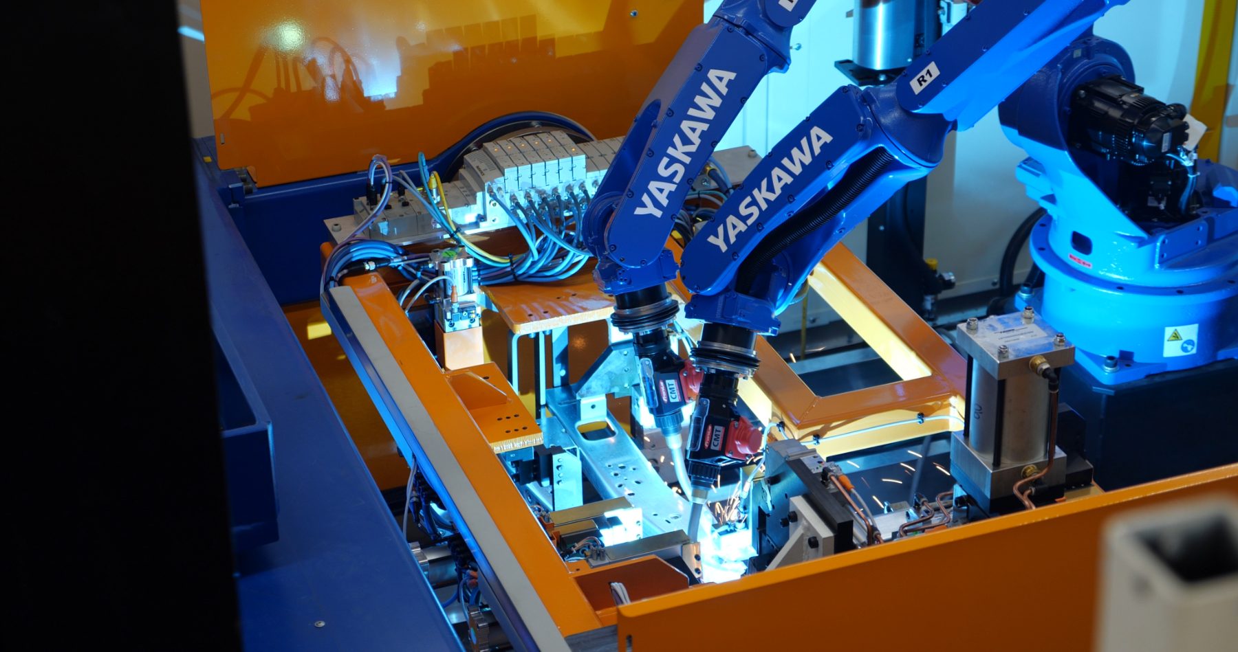 Close-up of industrial welding robots in motion, photographed for commercial media production
